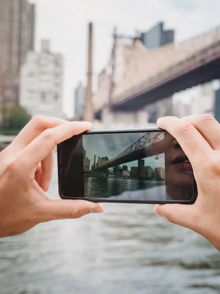 Someone photographing a city street with their phone