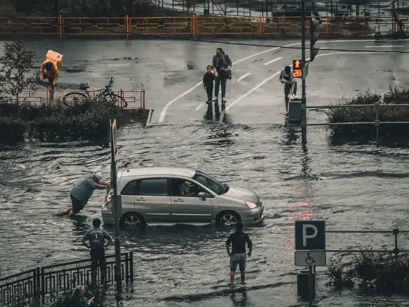 A flooded city street with water covering the roadway